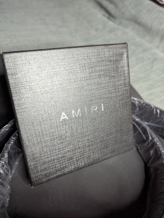 Amiri Belt gold and black logo