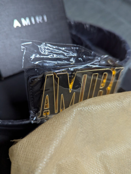 Amiri Belt gold and black logo