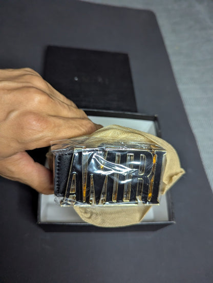 Amiri Belt gold and black logo