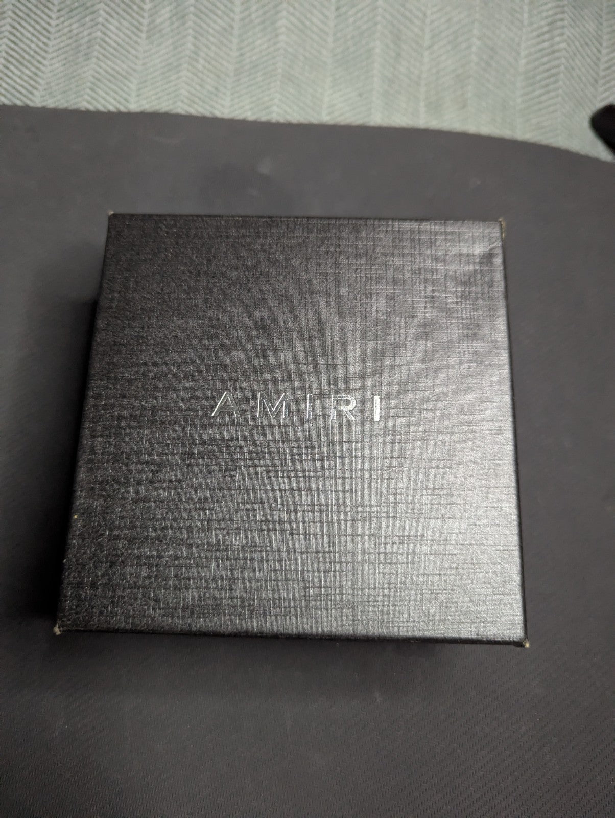 Amiri Belt gold and black logo