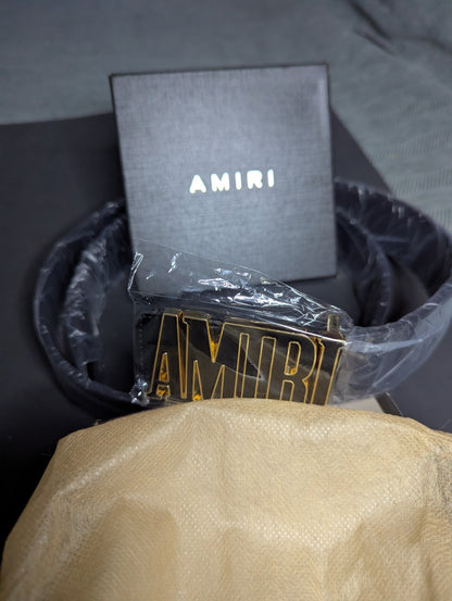 Amiri Belt gold and black logo