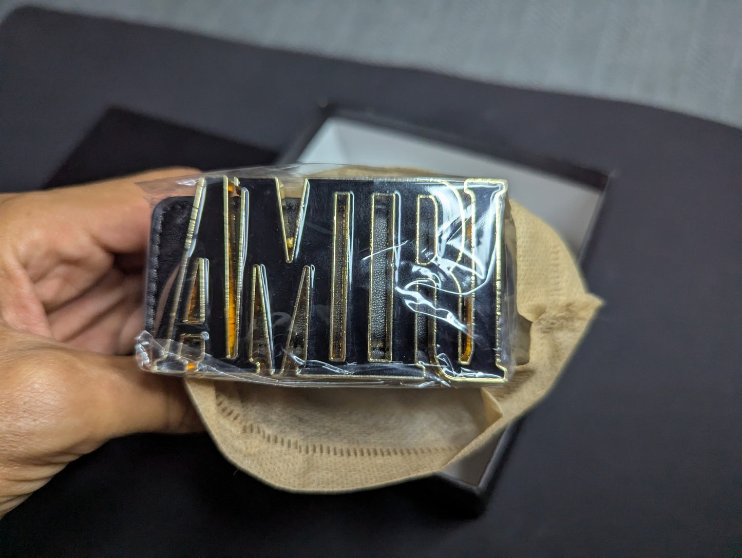 Amiri Belt gold and black logo